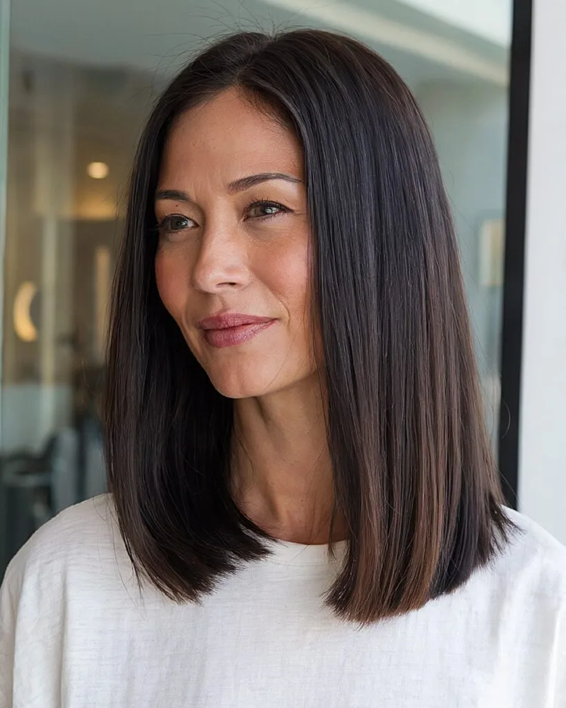 Straight medium-length haircut with blunt ends for over 40 women with sleek hair