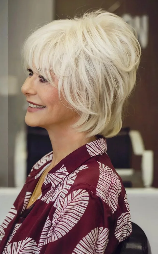 White Shaggy Wolf Cut Bob with Face-Framing Layers and Bangs for 70-Year-Olds