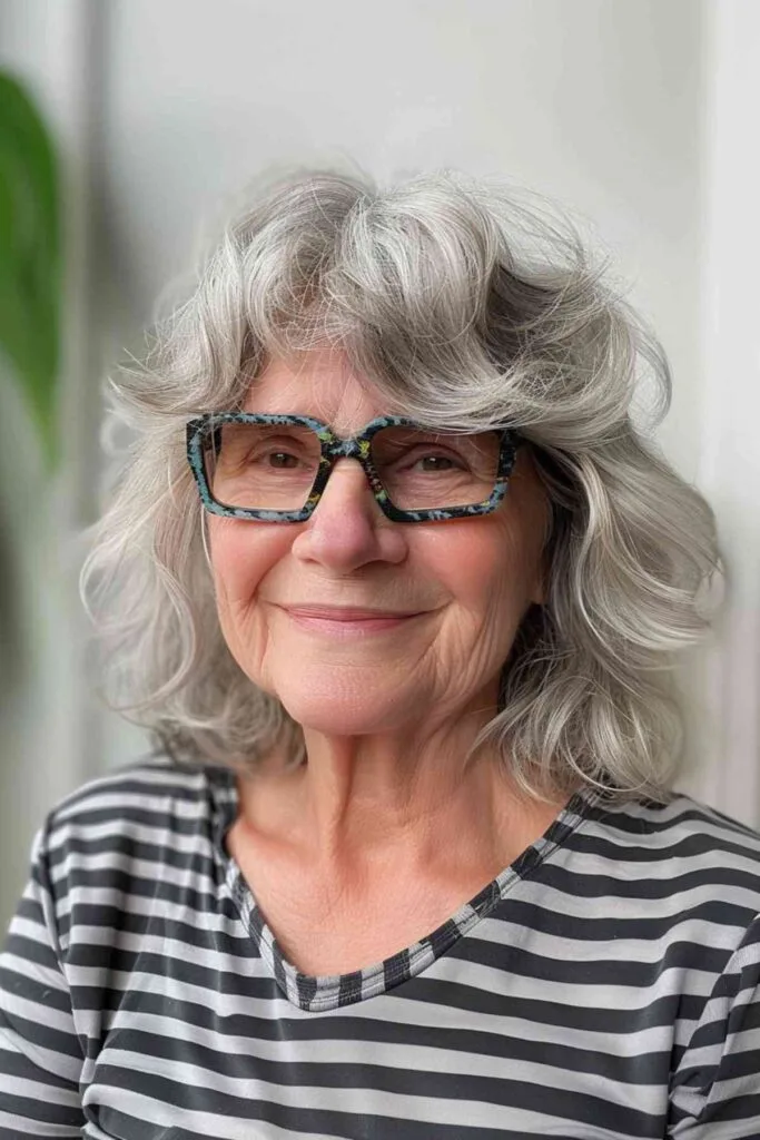 Woman with a square face shape, softened by a textured hairstyle with light, wispy bangs enhancing her features.