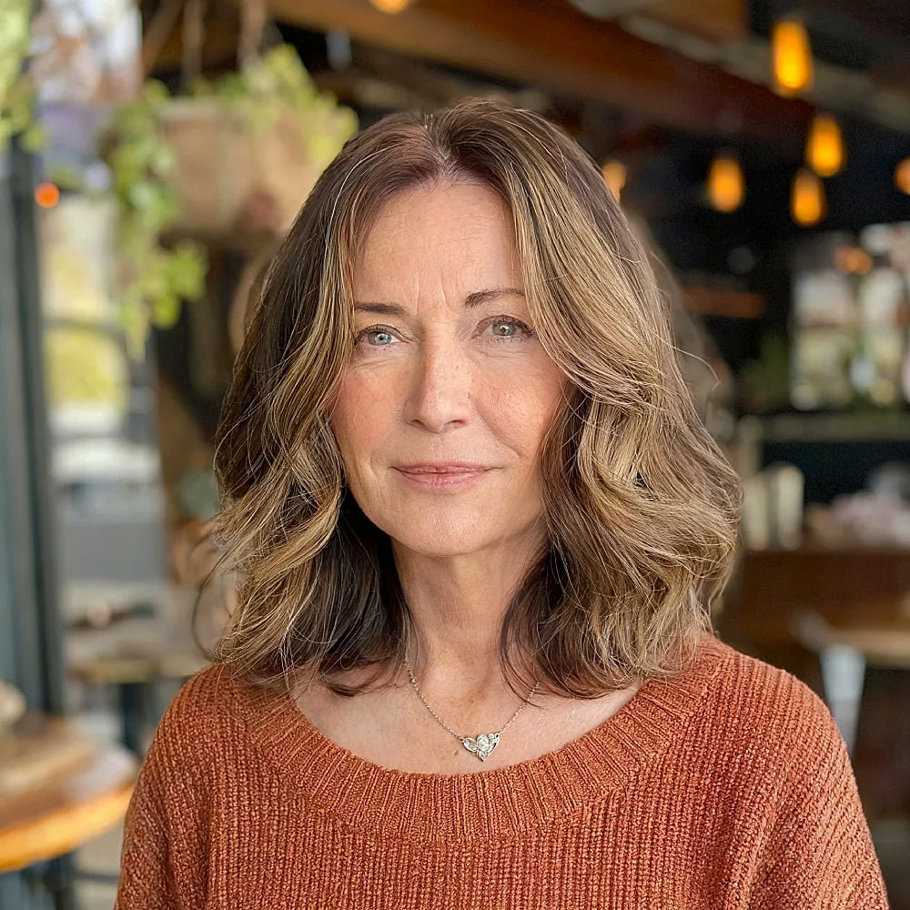 Brunette long bob with soft waves and subtle balayage for older women