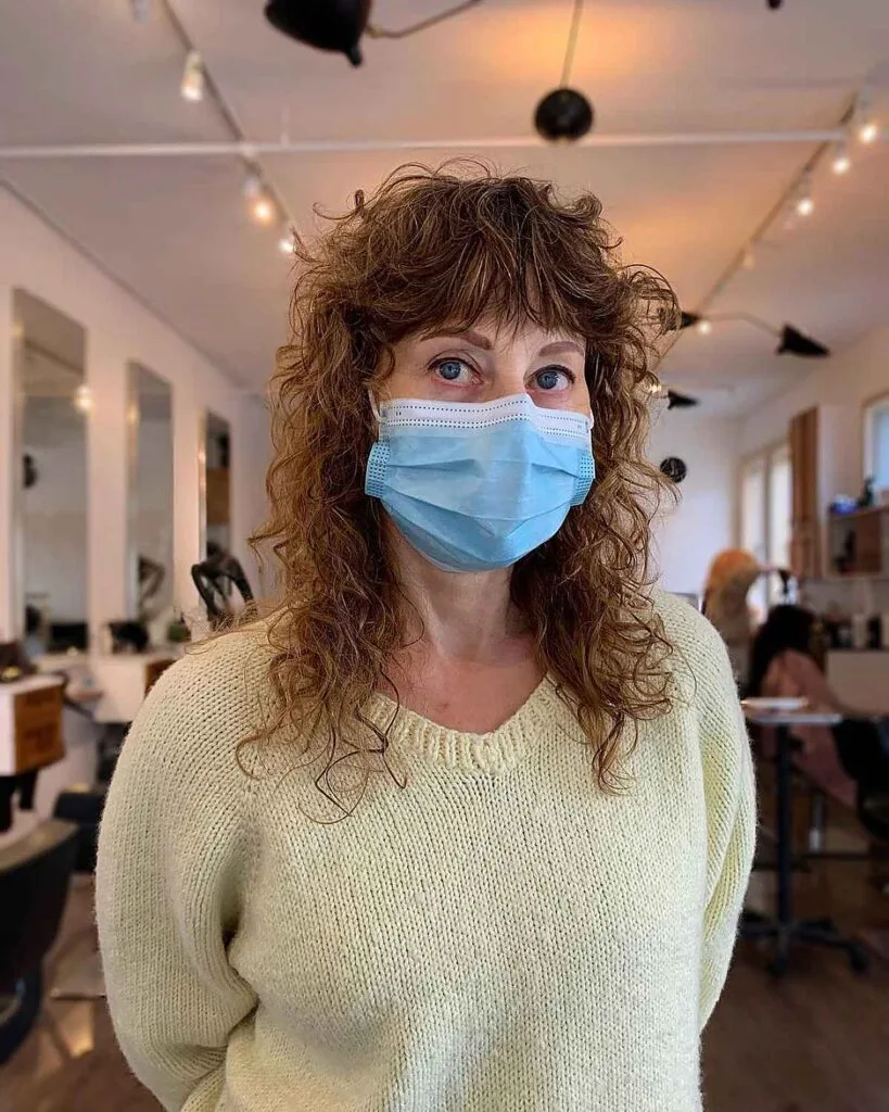 Chic Medium Curly Hairstyle with Shagged Layers for 60-Year-Old Women