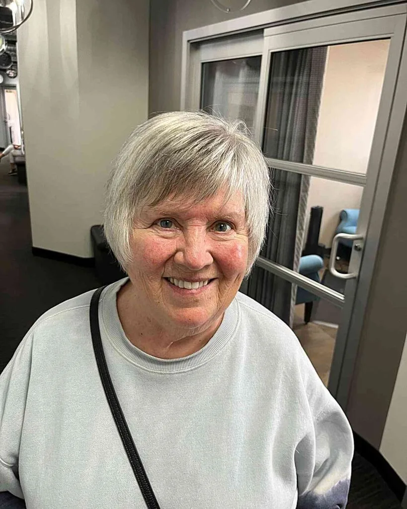 Ear-Length Short Hair with Side-Swept Pixie for Seniors Over Fifty with Round Face Shapes