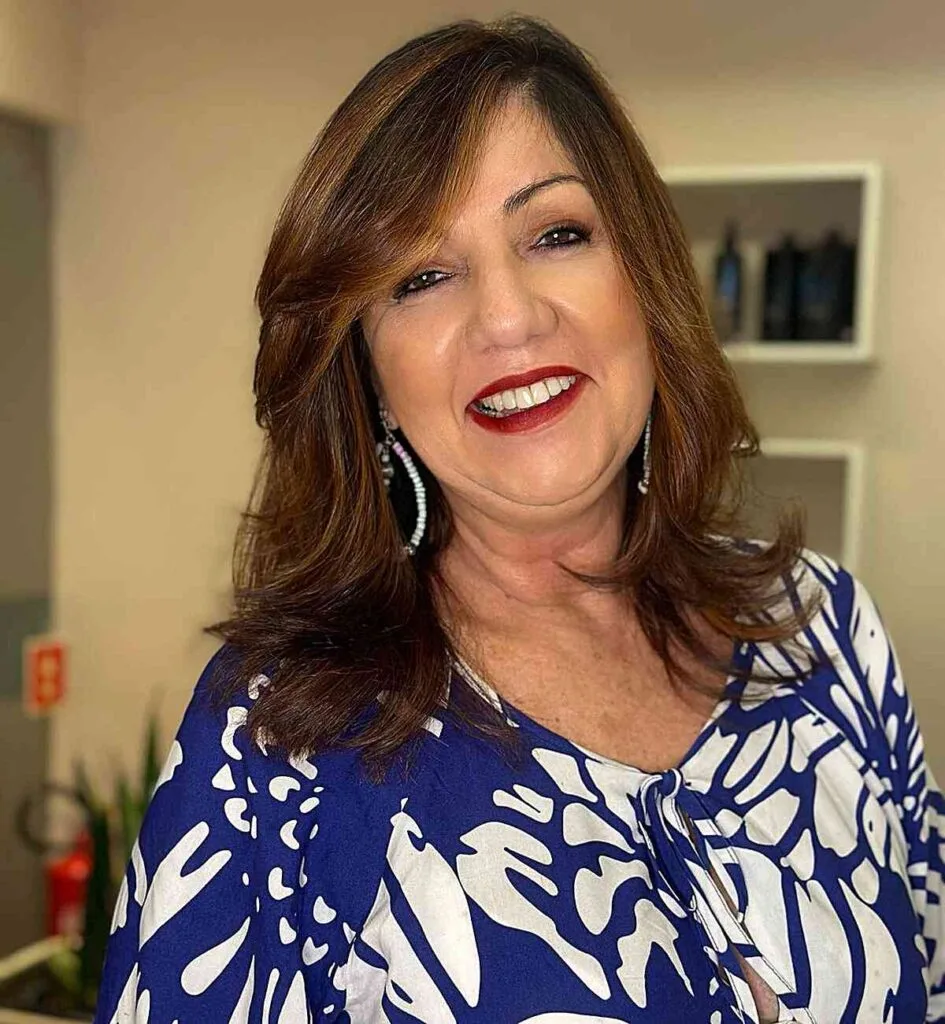 Elegant Side-Swept Mid-Length Hairstyle for Ladies Over Fifty with dark brown hair
