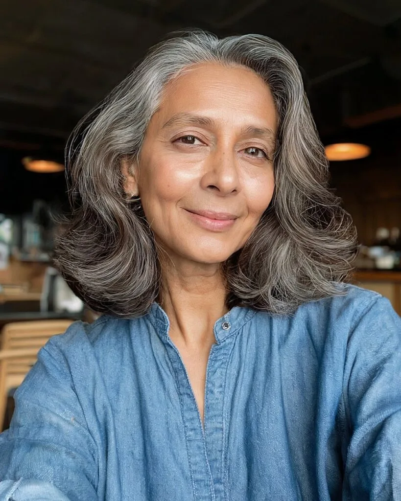 Medium brown hair with gray highlights softly blended for women over 50