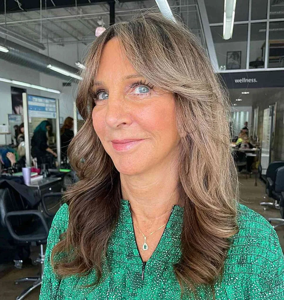 Mid-Length Bouncy Butterfly Hairstyle with Curtain Bangs for Ladies Over 50