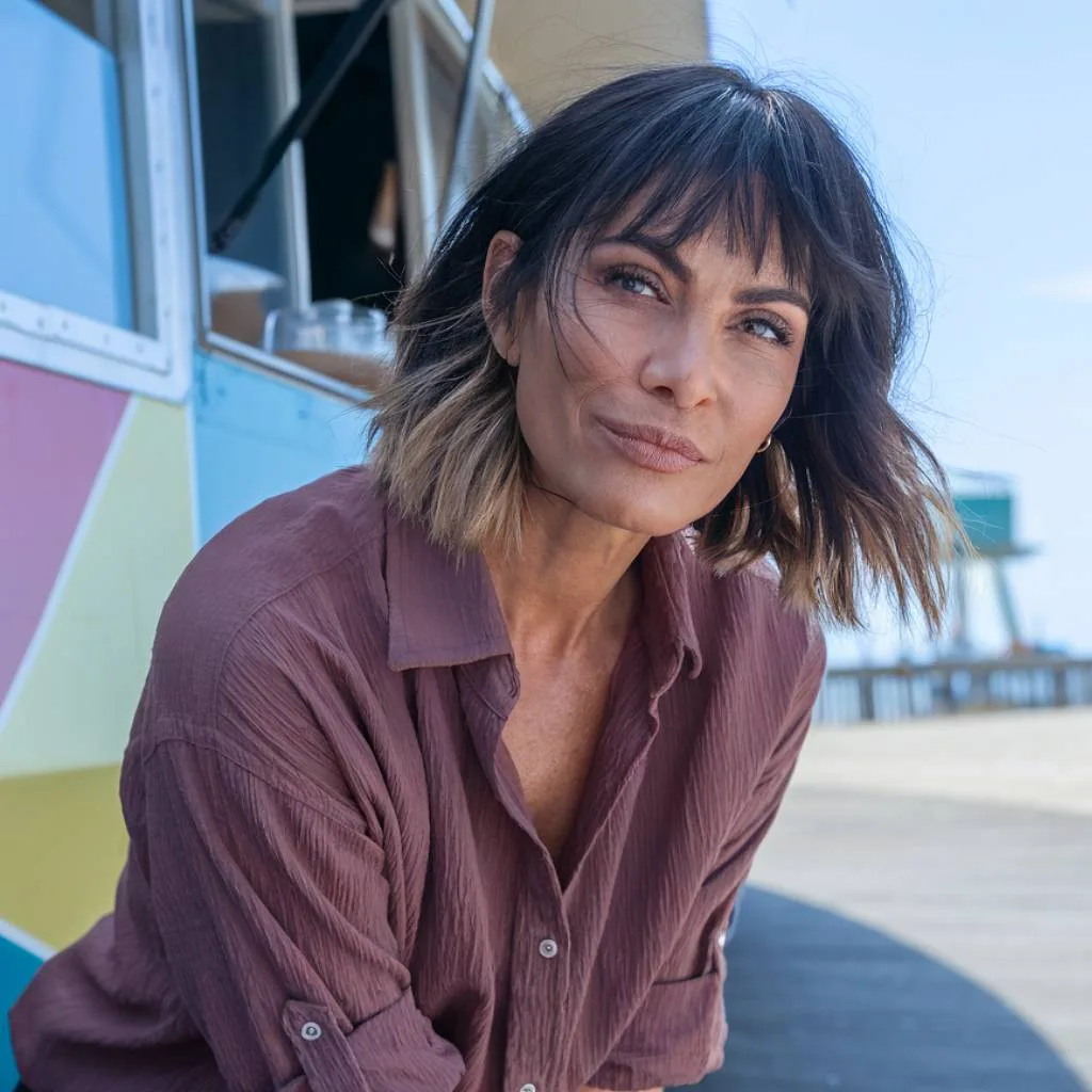 Shaggy bob with choppy ends and wispy bangs for fine hair over 40 with brunette ombré