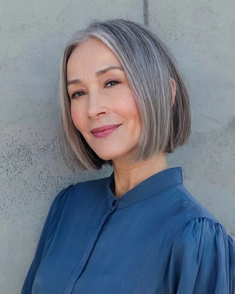 Short ash gray balayage bob with blunt ends for women over 50 seeking a sleek modern cut
