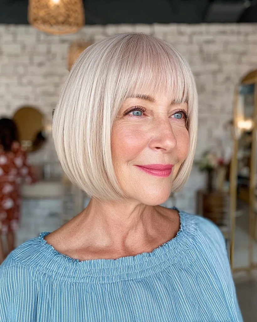 Short rounded bob with full fringe for older women with pale blonde fine hair