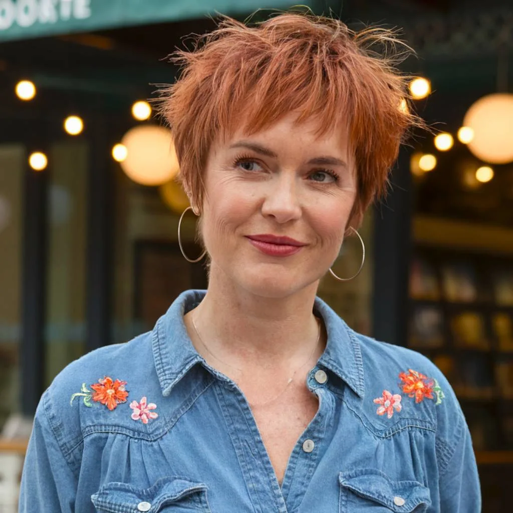 Short shaggy haircut with choppy layers for fine hair over 40 in rich copper-red