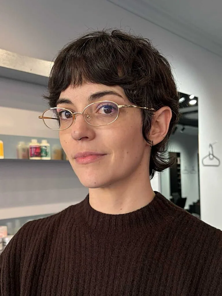 Short wavy brunette bixie with baby bangs and glasses