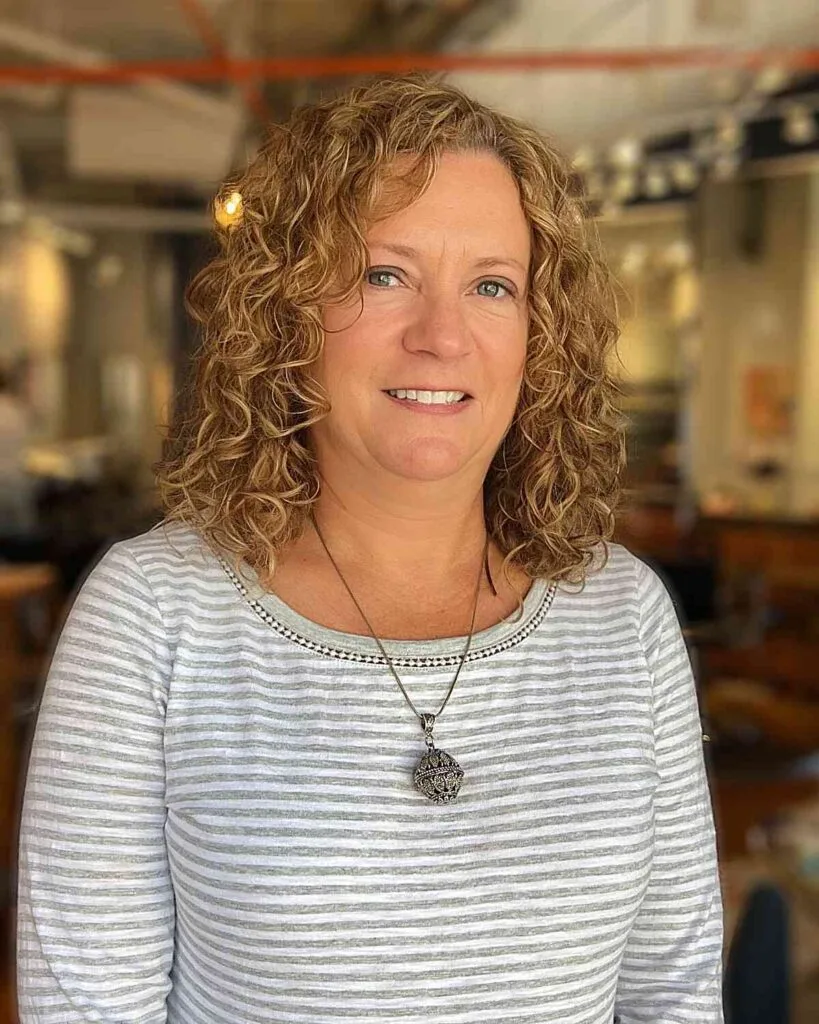 Side-Parted Curly Cut for Older Overweight Women Over 50 with Medium Hair