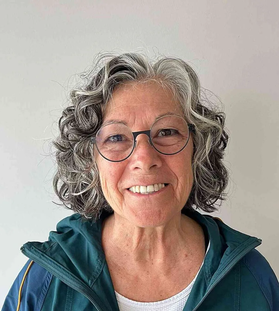 Stunning Natural Curls and Hairstyle for Women Aged 50 with Glasses