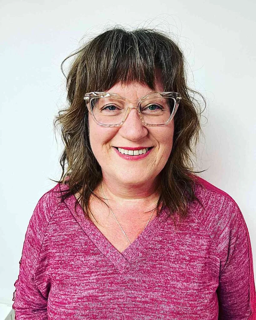Textured Mid-Length Shag with Bold Bangs for Women Over 60