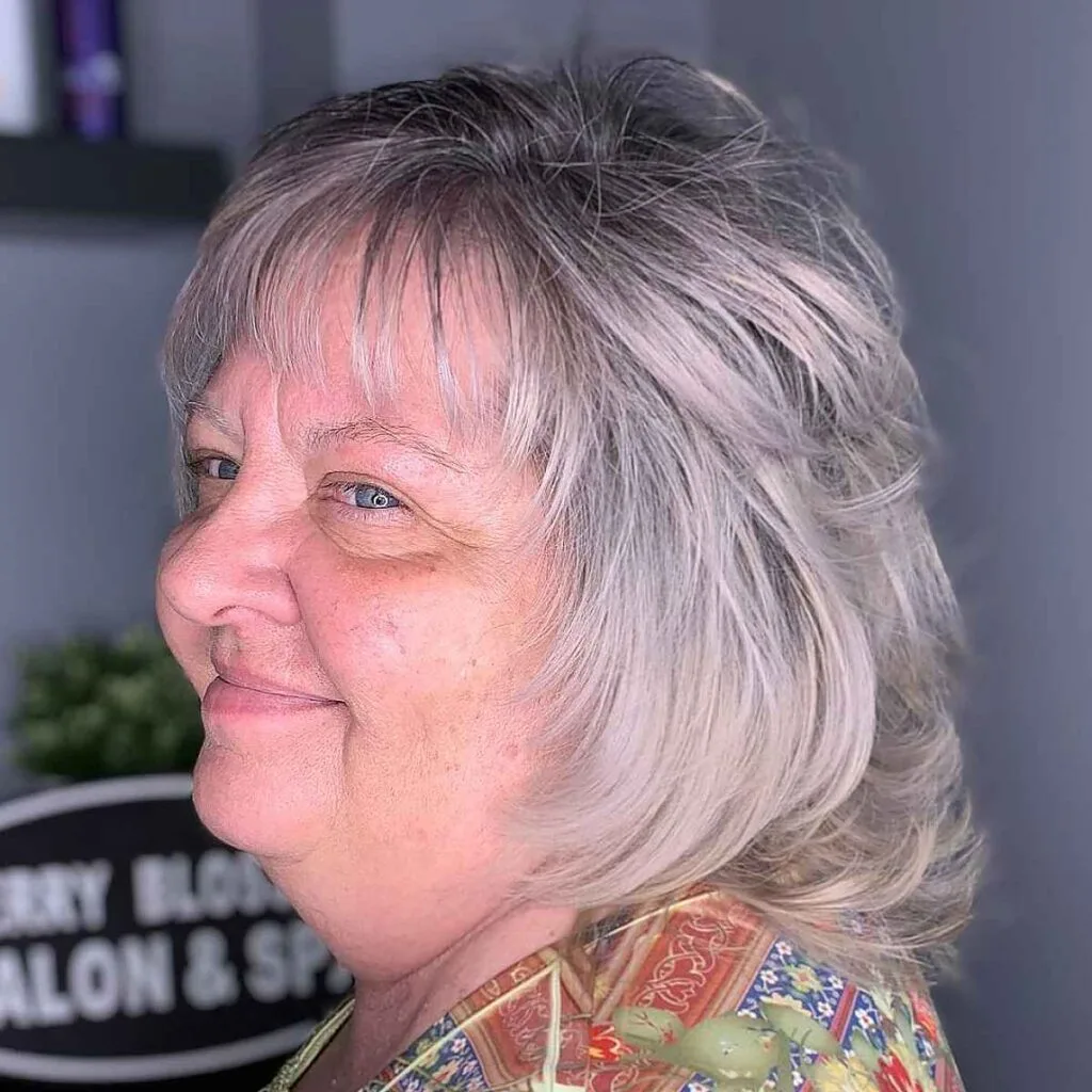 Textured Shag Haircut with Soft Bangs for Round Face Shapes