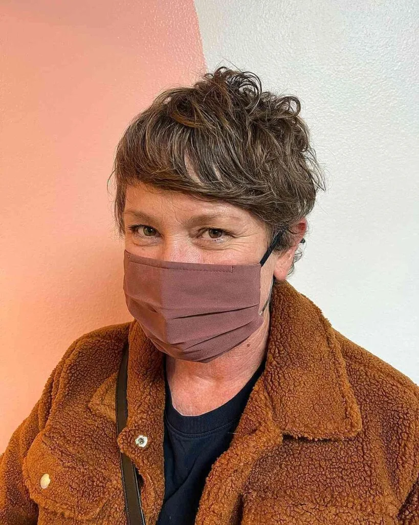 Tousled Pixie Shag Featuring Side-Swept Bangs for an Older Woman
