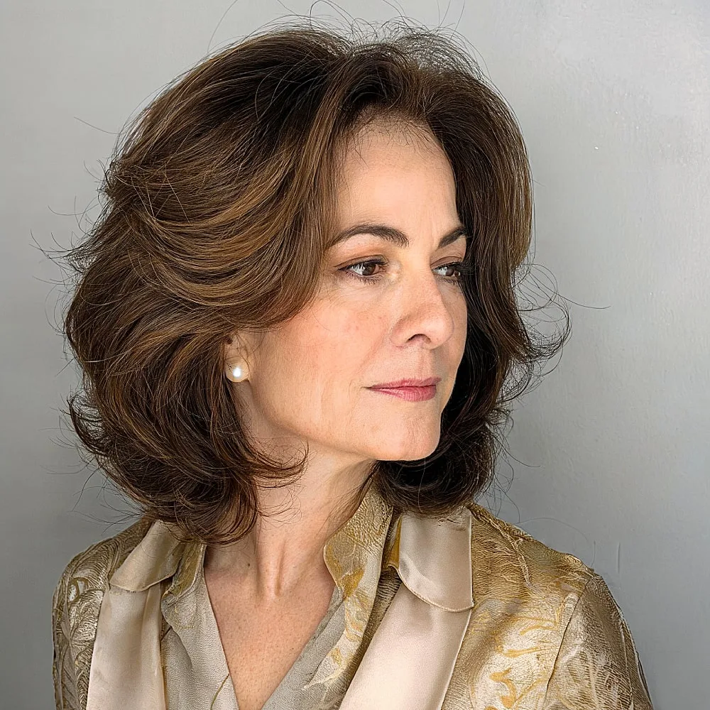 Vellabob hairstyle for mature women with voluminous layers and soft brunette waves