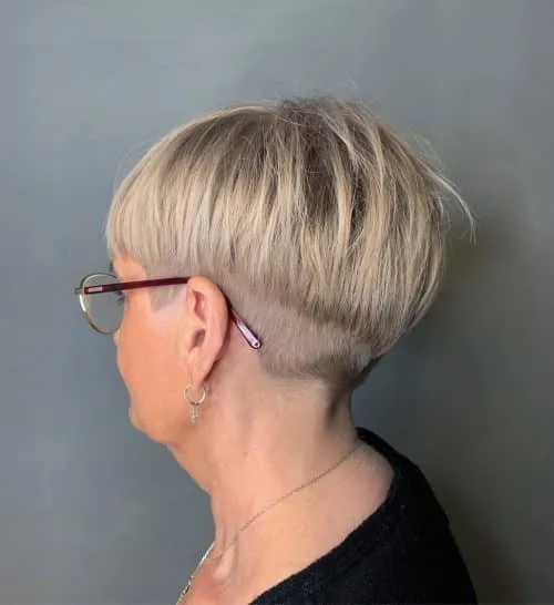 Youthful short cut for woman in her 50s and wearing glasses
