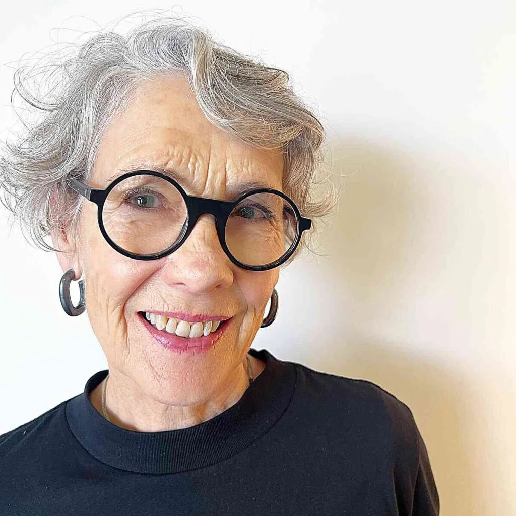 Adorable Short and Messy Hairstyle with Natural Hue for Women Aged 70 with Glasses