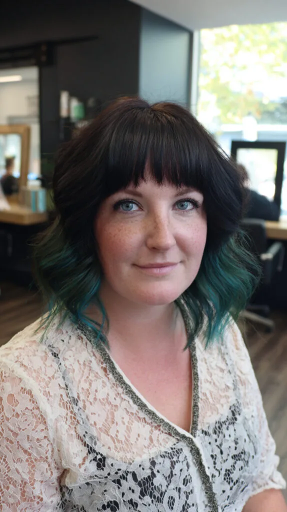 Bold Black and Teal Beachy Waves with Bangs