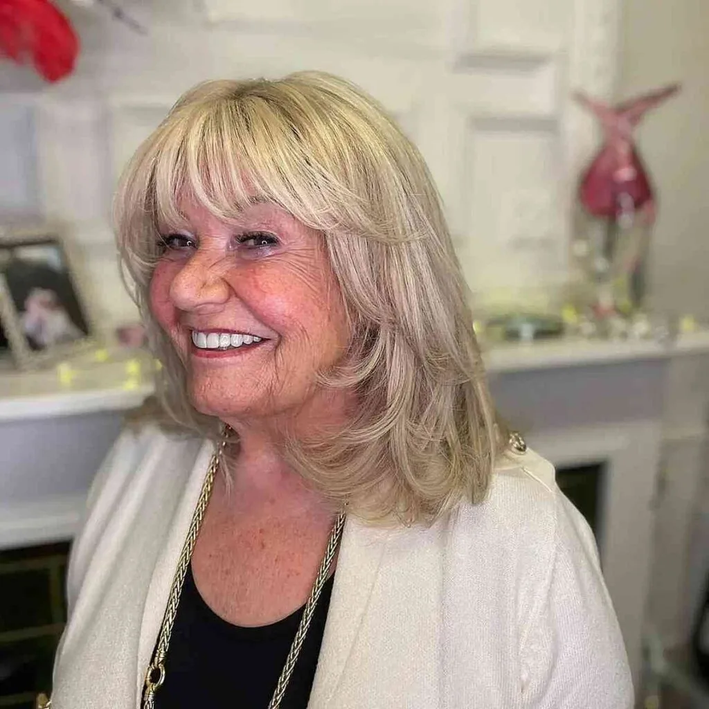 Chic Mid-Length Swoopy Layers with Soft Bangs
