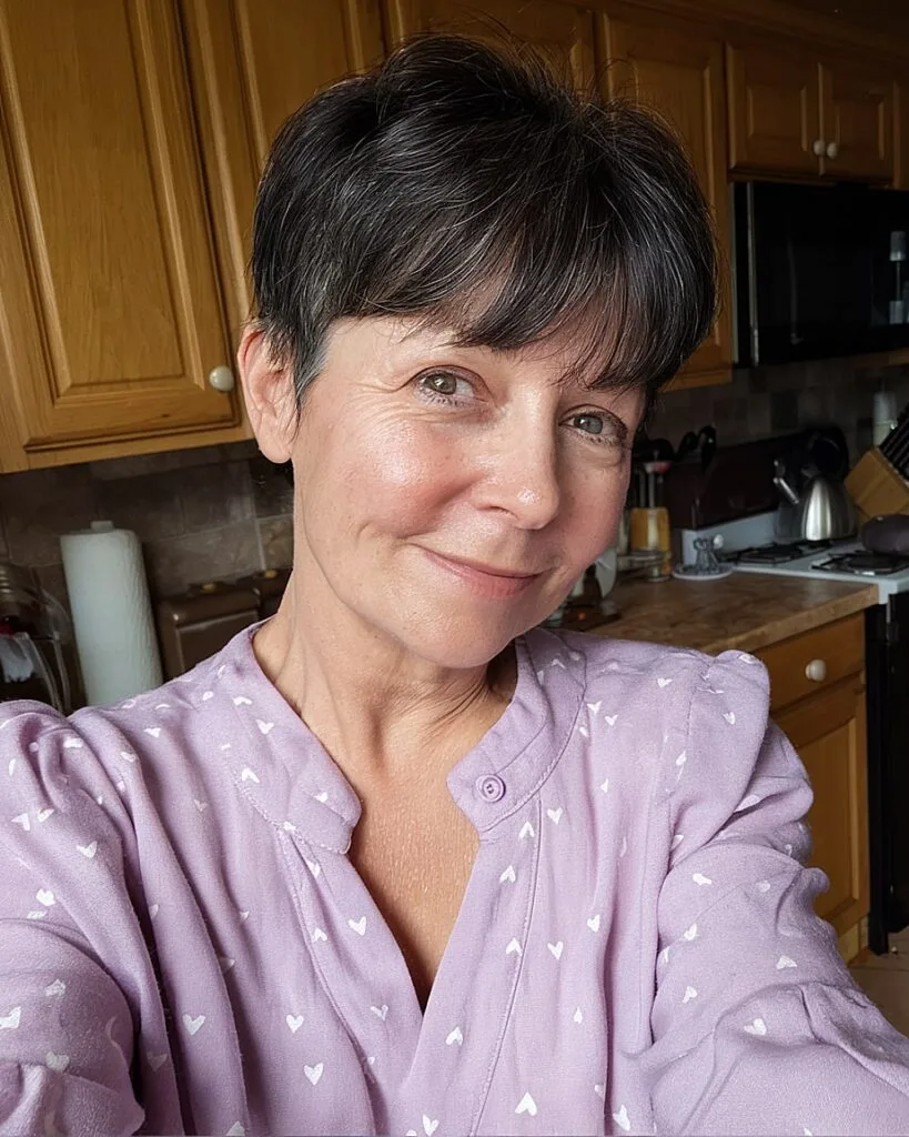 Cute soft pixie with bangs for round faces and thick dark hair over 50
