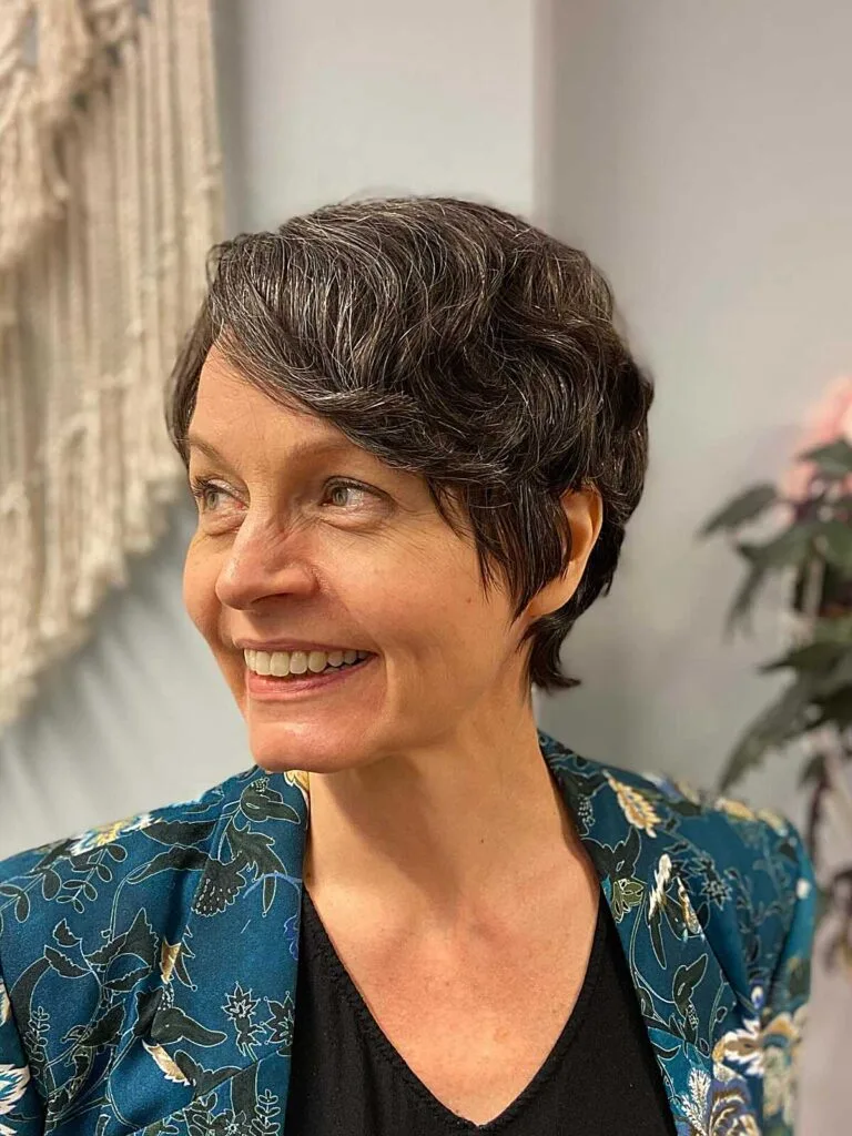 Dark wavy pixie-length bixie with natural grey streaks