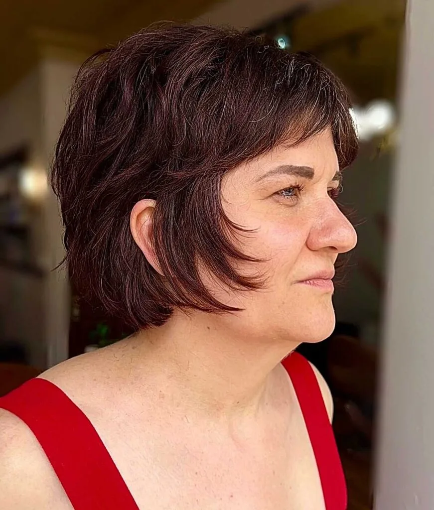 Deep plum shaggy bixie with wispy bangs and texture