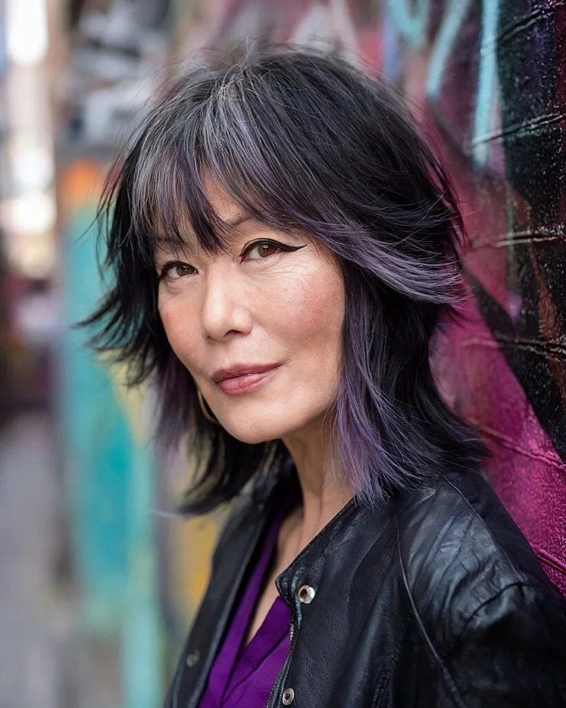 Jellyfish shag haircut with two-tier layers and bold purple accents for women over 50
