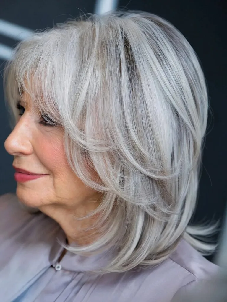 Multi-Layered Straight Haircut with Silver Highlights for Older Ladies Aged 60 with Medium Cut