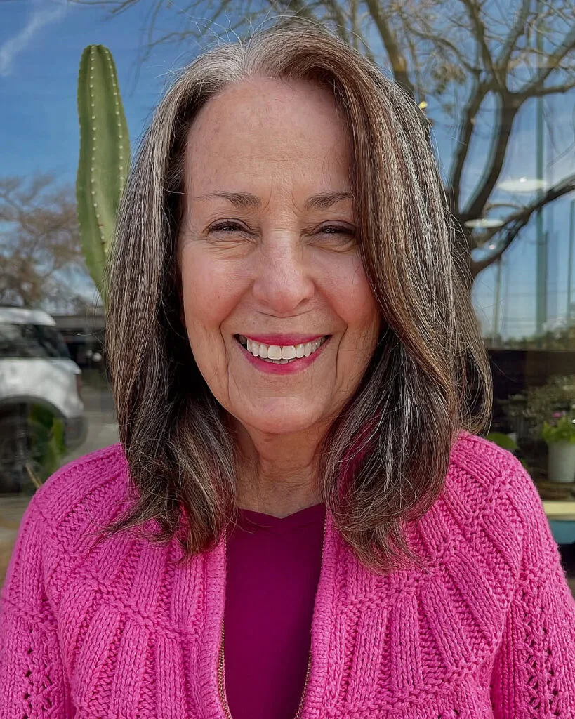 Natural long bob with face-framing layers for women over 60 with gray and brunette blend