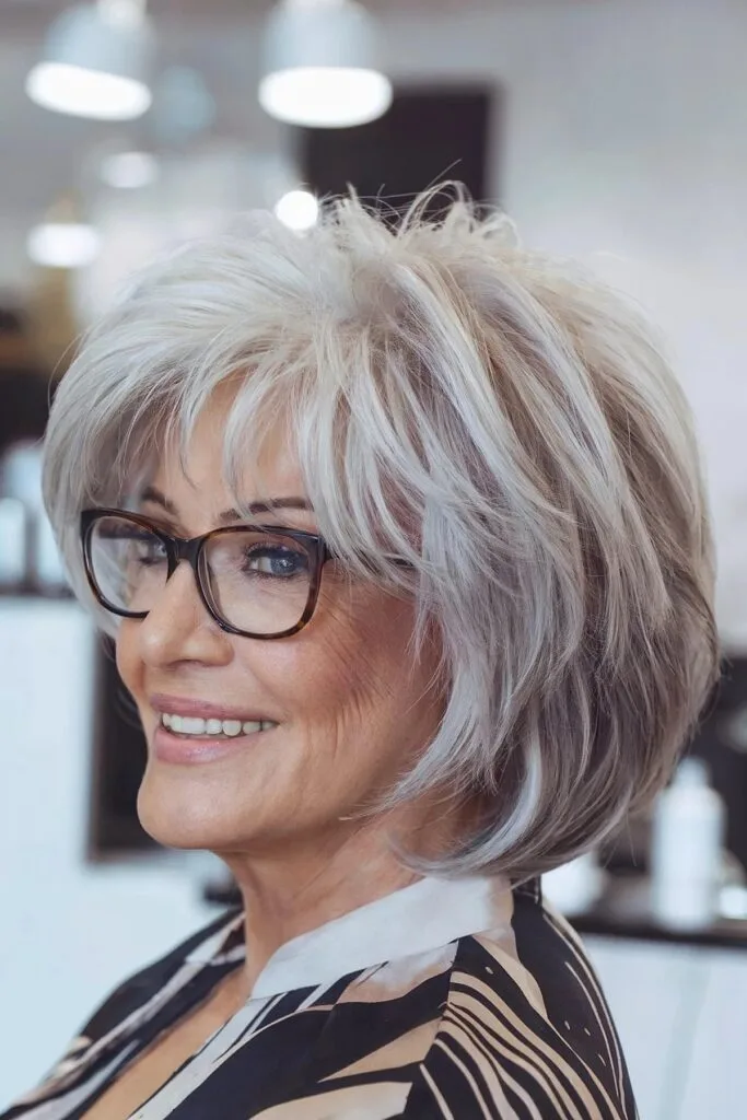 Sassy Short Hair with Feathered Choppy Layers and Balayage for Seniors Over 60 with Glasses