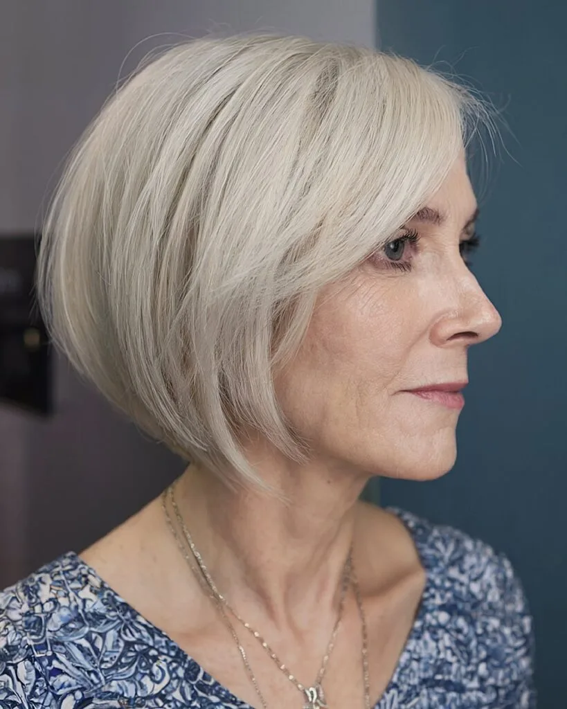 Sculpted chin-length bob for thick silver hair over 50 with soft side layers