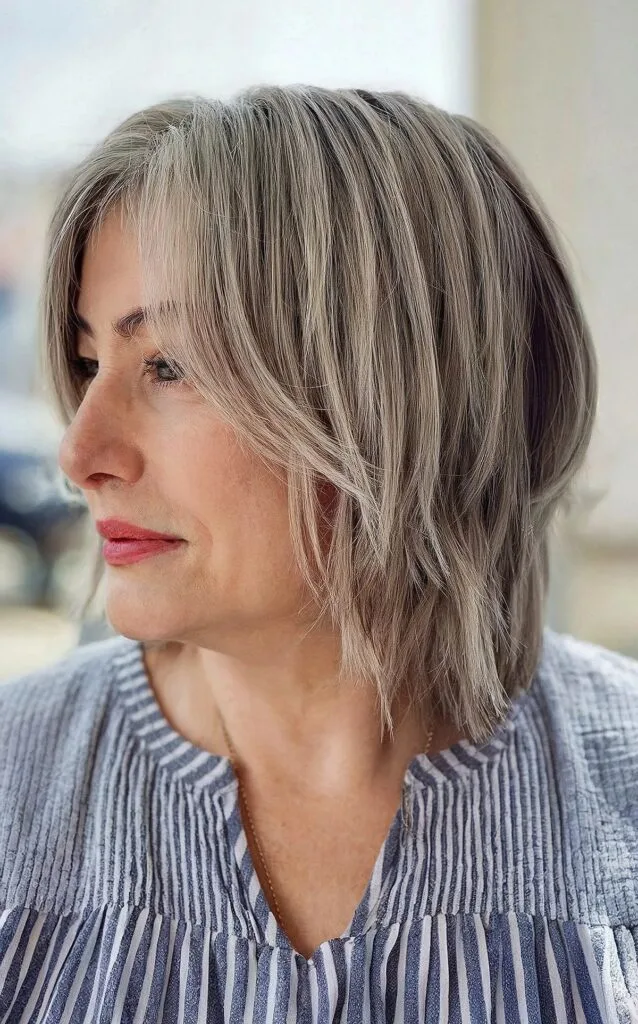 Shaggy layered bob with curtain bangs for women over fifty