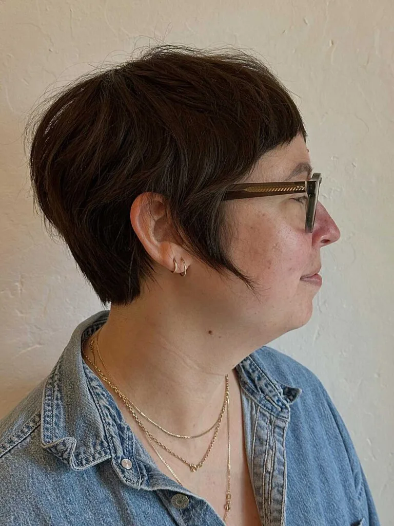 Short brunette bixie with side part and glasses