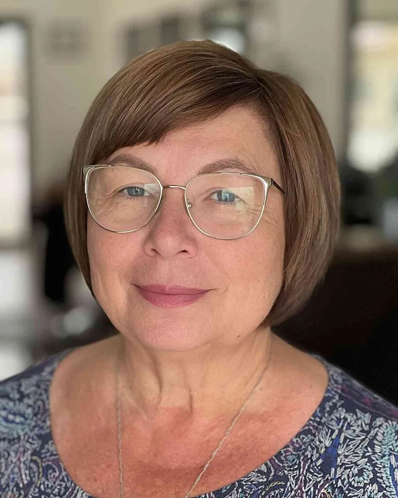 Sleek Bob with Side Bangs for 50-Year-Olds with Round Faces and Specs