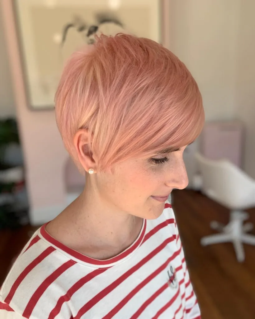Soft Blush Textured Pixie Cut with Side-Swept Bangs