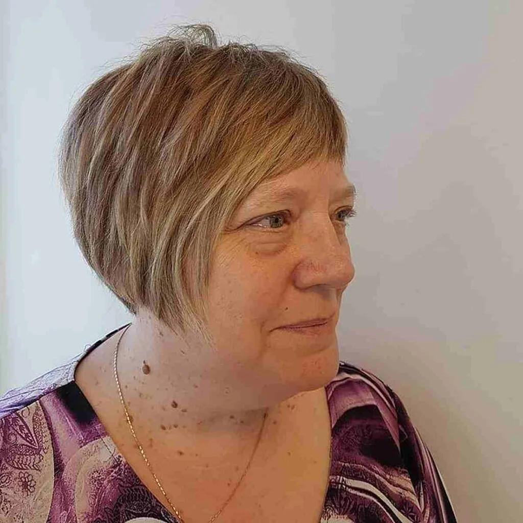 Textured Pixie Bob with Short Bangs for a 50-Year-Old Woman
