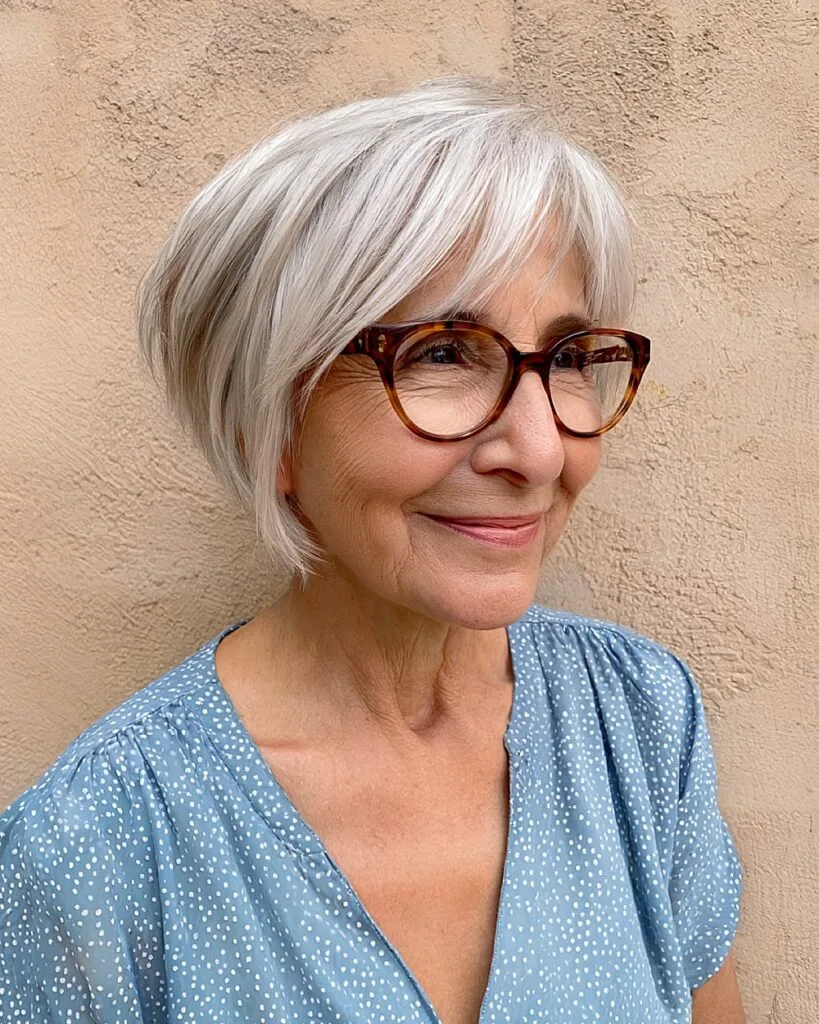 Textured silver pixie bob for older women with fine hair and soft side-swept bangs