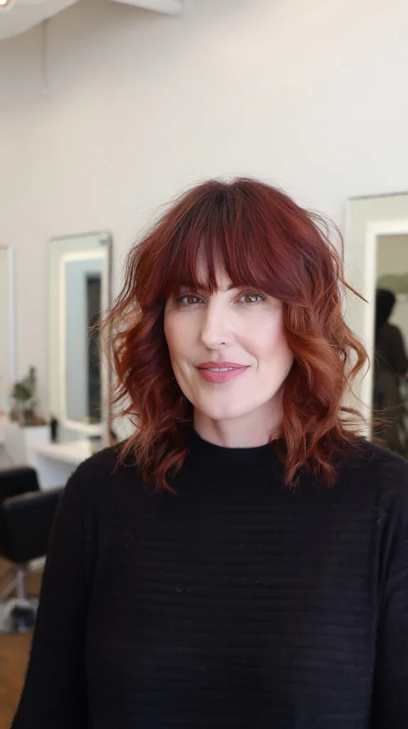 Vibrant Copper Waves with Soft Bangs