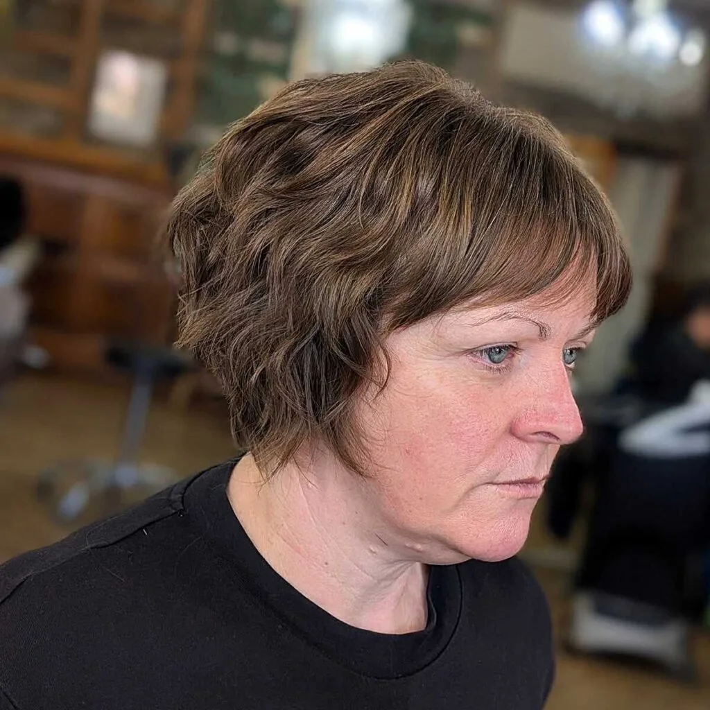 Wavy brown bixie with curtain bangs on mature woman