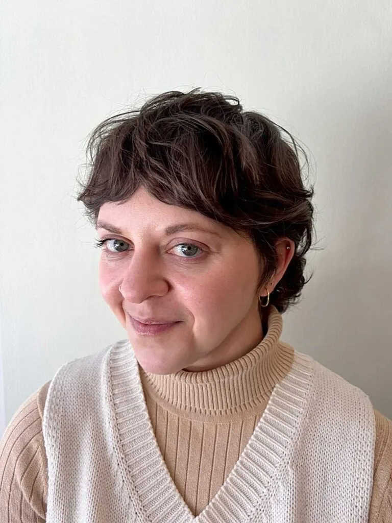Wavy dark brunette bixie with short fringe and volume