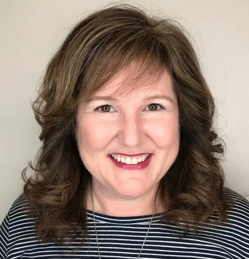 Chic Layered Curls with Soft Bangs
