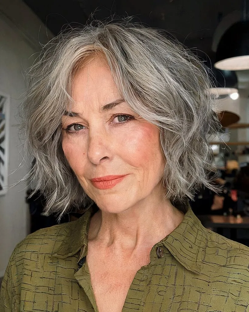 Chin-length wavy bob with ash grey balayage for women over 60