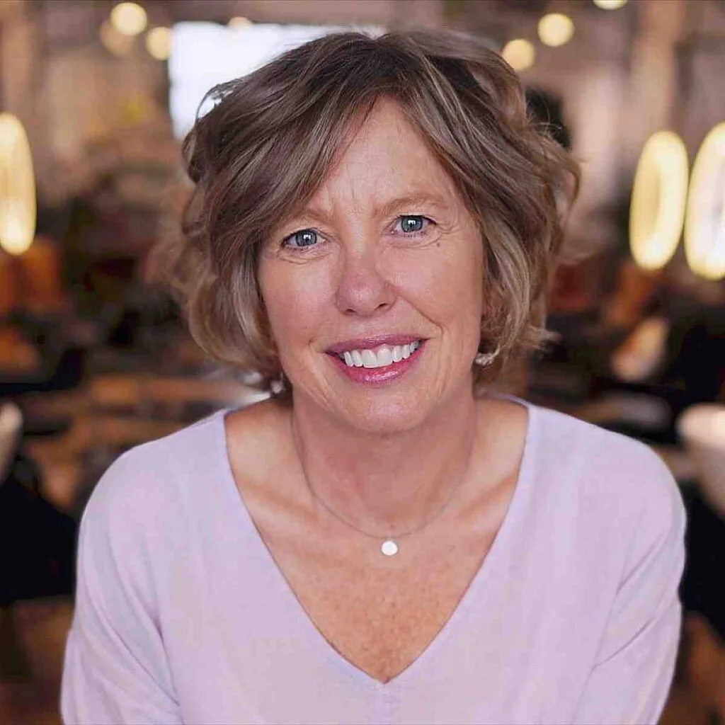 Elegant jaw length bob with extended bangs for ladies over 60