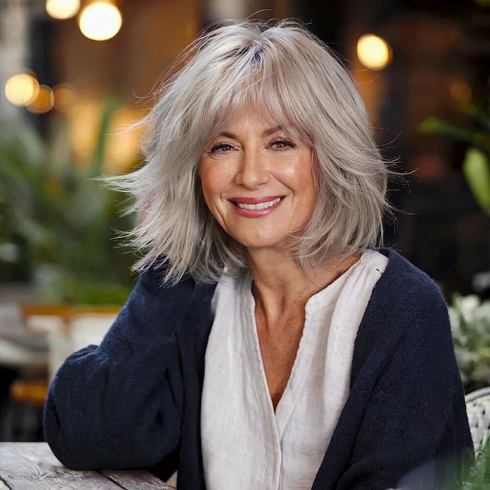 Medium shag haircut with choppy layers and feathered ends, perfect for adding volume and movement to fine or thinning hair