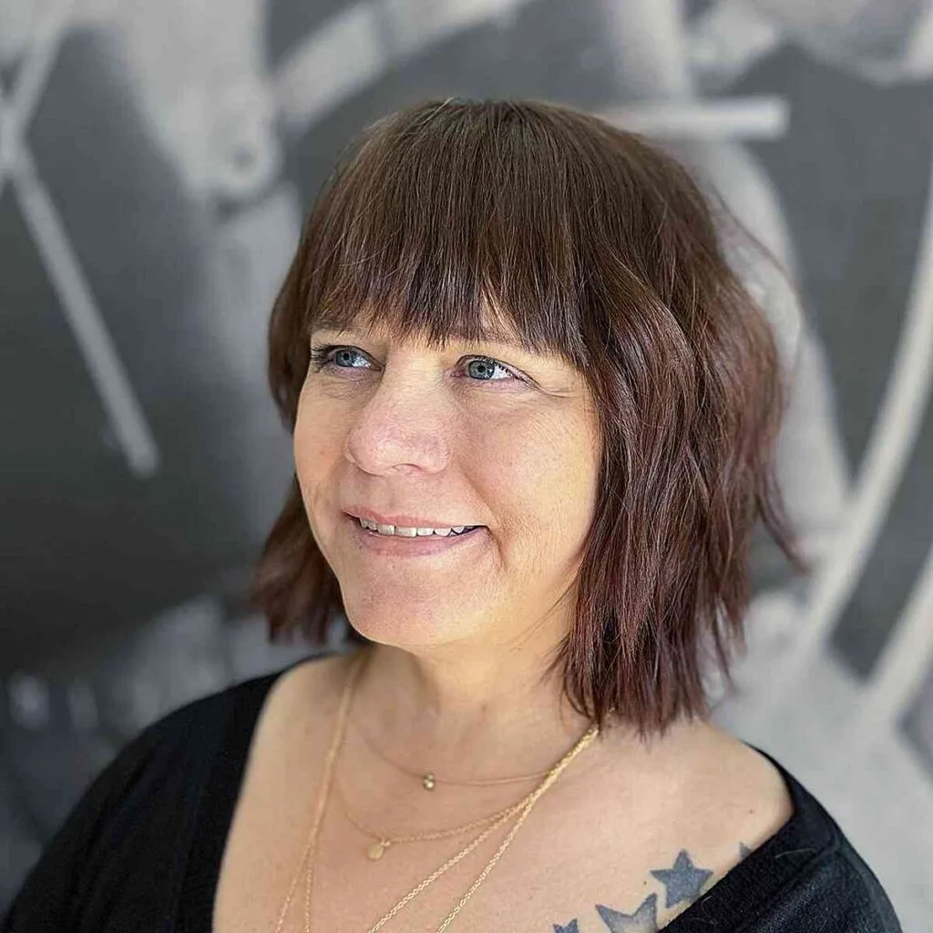 Neck-Grazing Razor Cut Bob with Front Bangs for Women Aged 50
