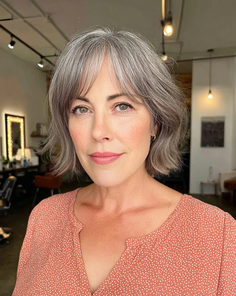 Short wavy gray bob with curtain bangs for older women with fine to medium hair