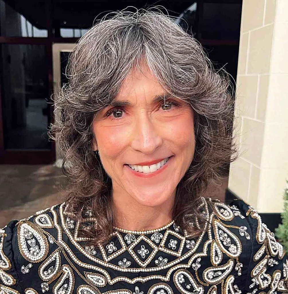 Shorter-Length Shag Cut with Flipped Layers and Curtain Bangs for Old Women with Gray Hair