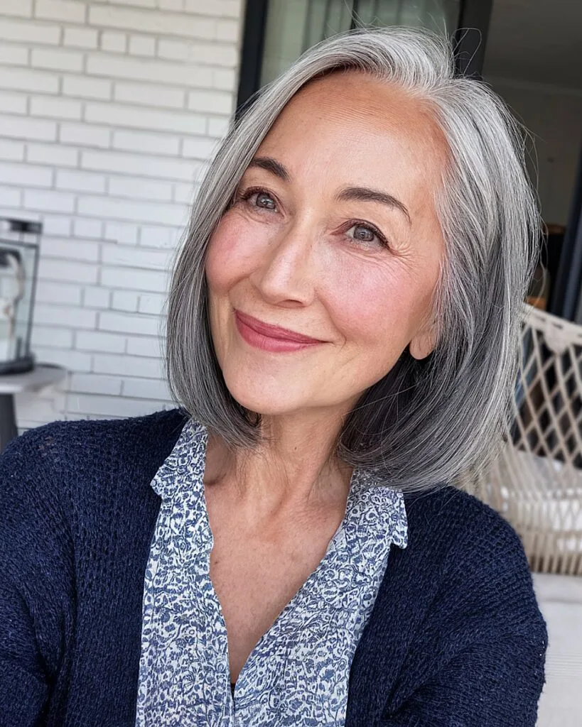 Shoulder-grazing bob with grey ombre on straight hair for women over 60
