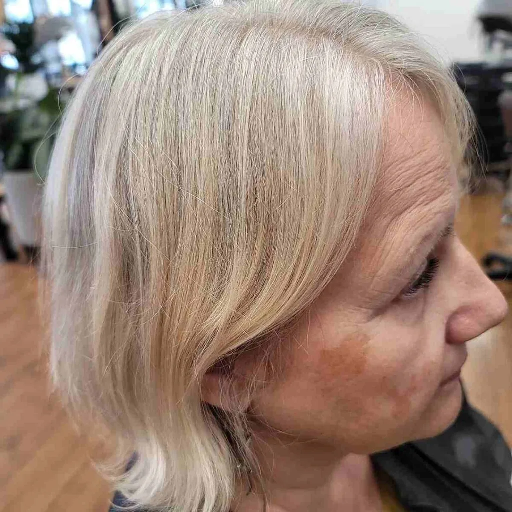 Stunning Gray Bob with Long Side Swept Bangs for Ladies Over Sixty